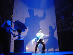 A shadow of Elvis Presley. Mario Kombou plays the Elvis role in Jailhouse Rock (Piccadilly Theatre, 2004) photo: Jonathan Alver